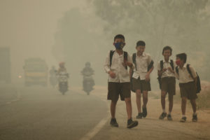 Students walk along a street as they are released from school to return home earlier due to the haze in Jambi, Indonesia's Jambi province, September 29, 2015 in this file picture taken by Antara Foto. Antara Foto/Wahdi Setiawan/via REUTERS/File Photo ATTENTION EDITORS - THIS IMAGE WAS PROVIDED BY A THIRD PARTY. FOR EDITORIAL USE ONLY. MANDATORY CREDIT. INDONESIA OUT. - RTSOJCY